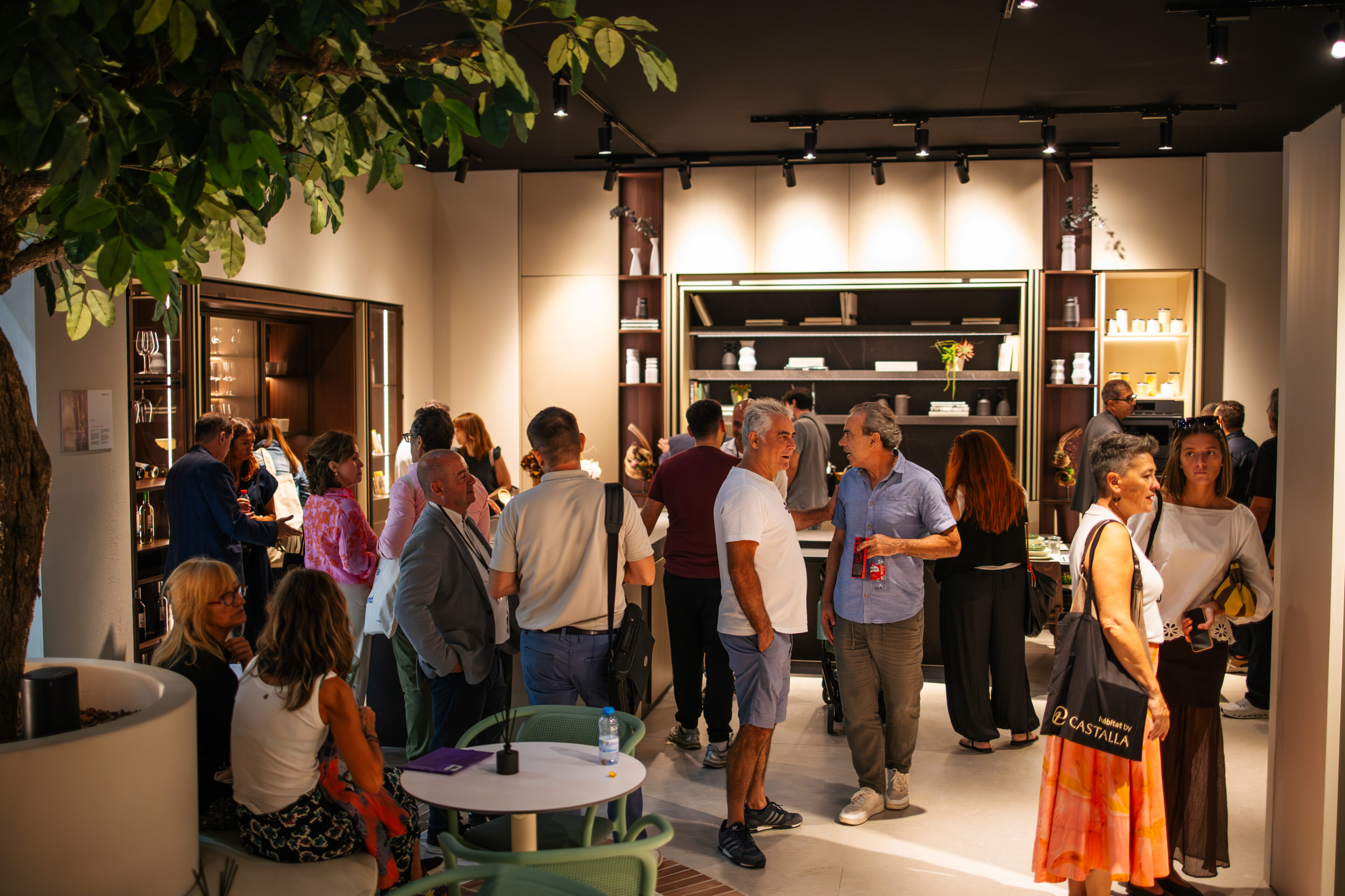 Grupo de personas en un showroom de cocinas con productos y decoración moderna